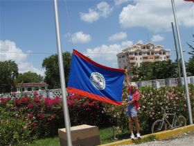 Woman holding Belize flag – Best Places In The World To Retire – International Living